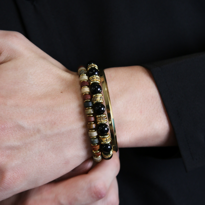Close-up of Picasso Stone disc beads on a mens bracelet