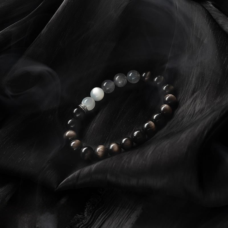 Elegant healing crystal bracelet with moonstone and obsidian on black silk
