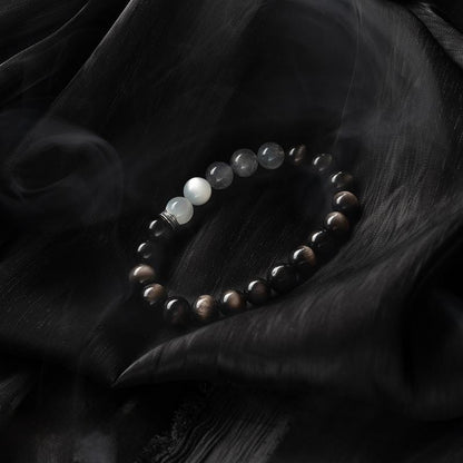 Elegant healing crystal bracelet with moonstone and obsidian on black silk
