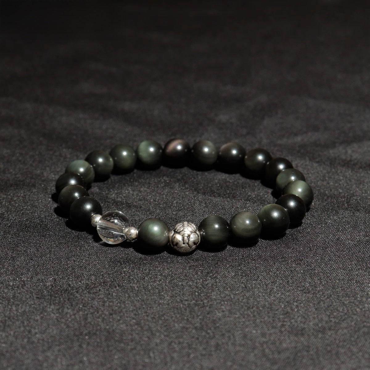 Front view of obsidian Pixiu healing stone bracelet with quartz crystal beads